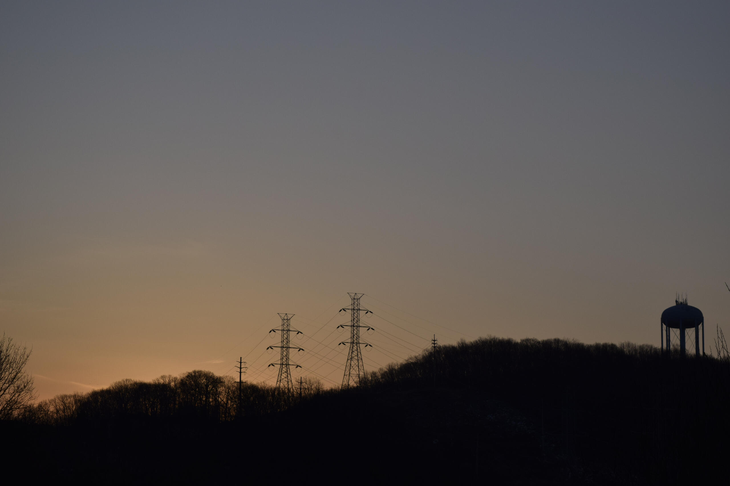 A nice sunrise filled sky with trees to compliment it.